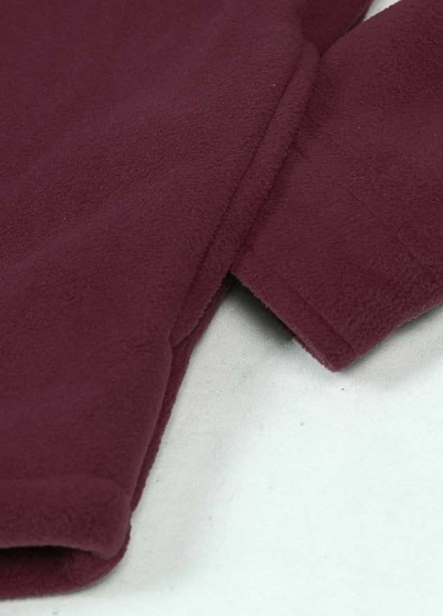 Close-up of a womens sherpa lined burgundy fleece shacket hand pocket