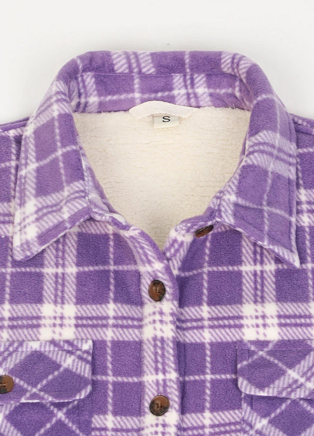 Detailed view of the collar on a womens purple white plaid fleece shirt jacket