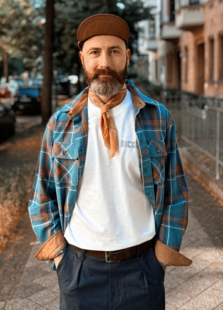 Front view of a man wearing a blue cozy plaid flannel shirt for men wearing a hat