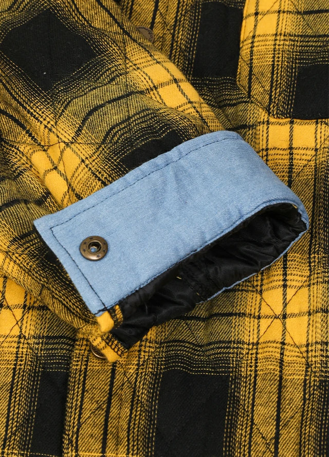 Detailed view of roll up cuff of yellow black men's quilted lined plaid shacket