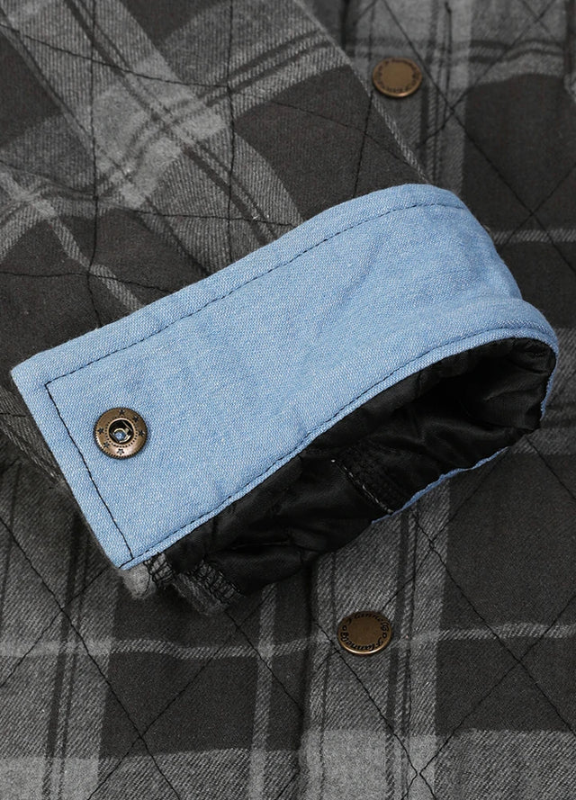 Close-up of the roll up cuff of black gray men's quilted lined plaid shacket