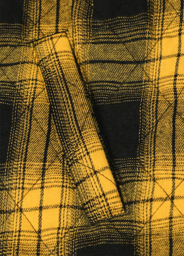 Close-up of the handpocket of yellow black men's plaid shirt jacket with quilted lining