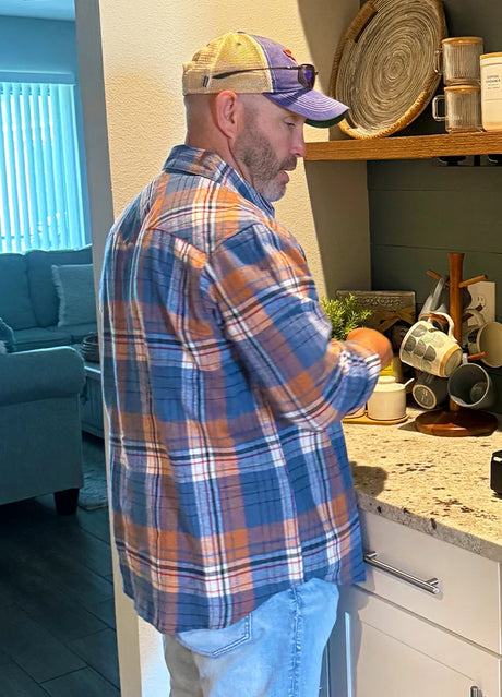 Back view of a man in a blue orange men's warm long sleeve western flannel shirt