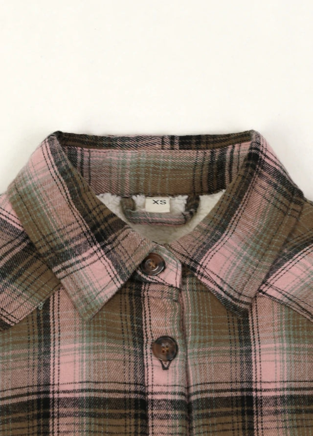 Close-up of the collar on a women's long-sleeve pink brown flannel jacket for winter