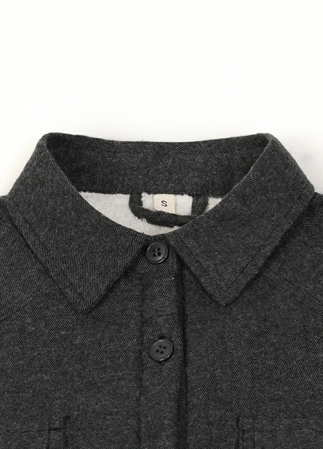 Close-up of the collar on a women's long-sleeve dark gray flannel jacket for winter