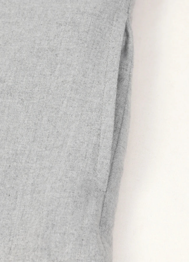 Detailed view of women's solid gray long sleeves flannel shacket side pocket