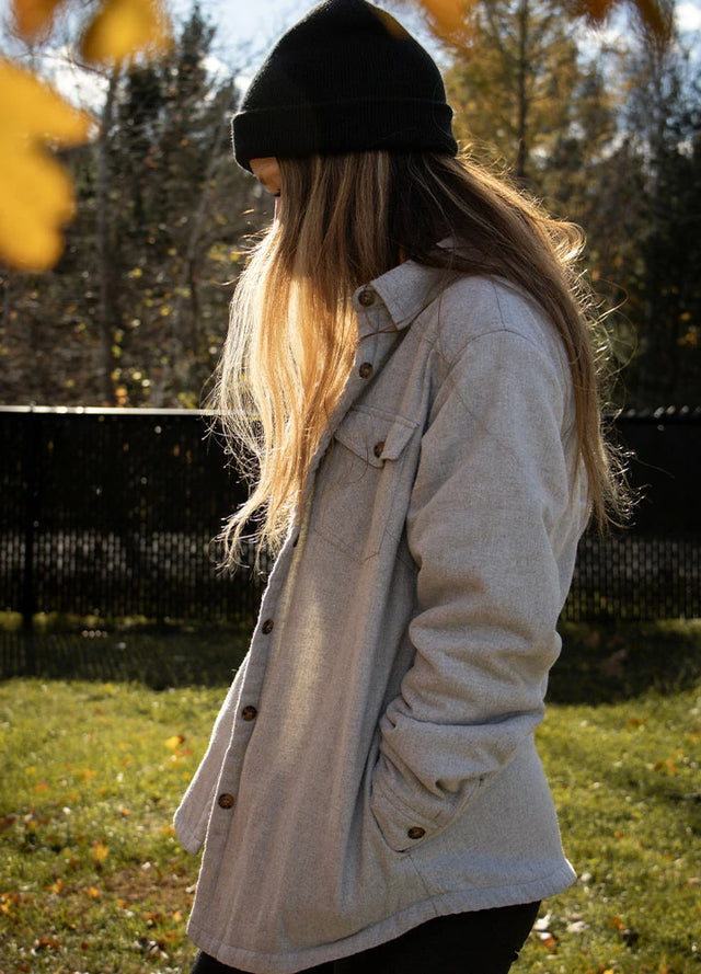 Side view of a woman in a solid gray flannel shacket with sherpa lined