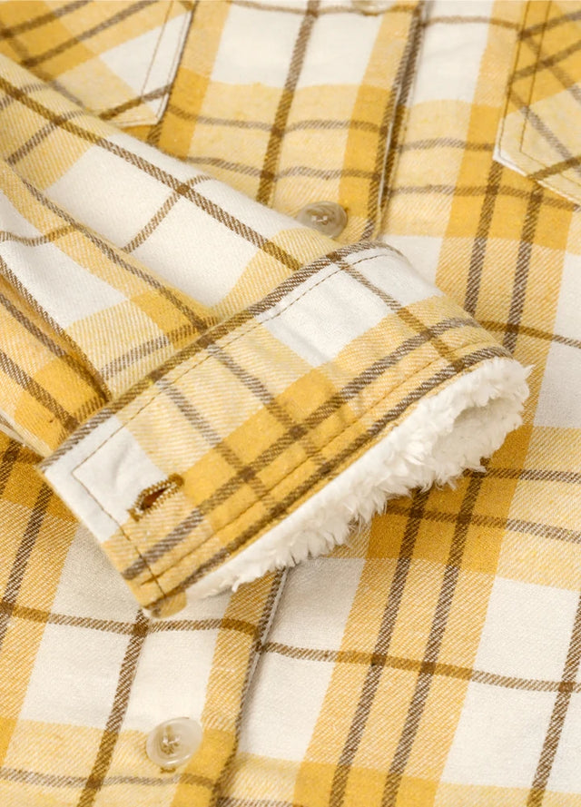Zoomed-in view of the cuff on a womens button down khaki yellow flannel jacket