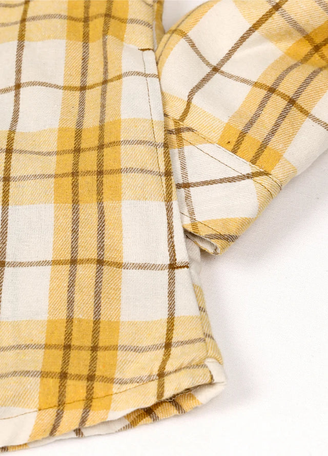 Detailed view of women's khaki yellow sherpa-lined flannel shacket hand pocket