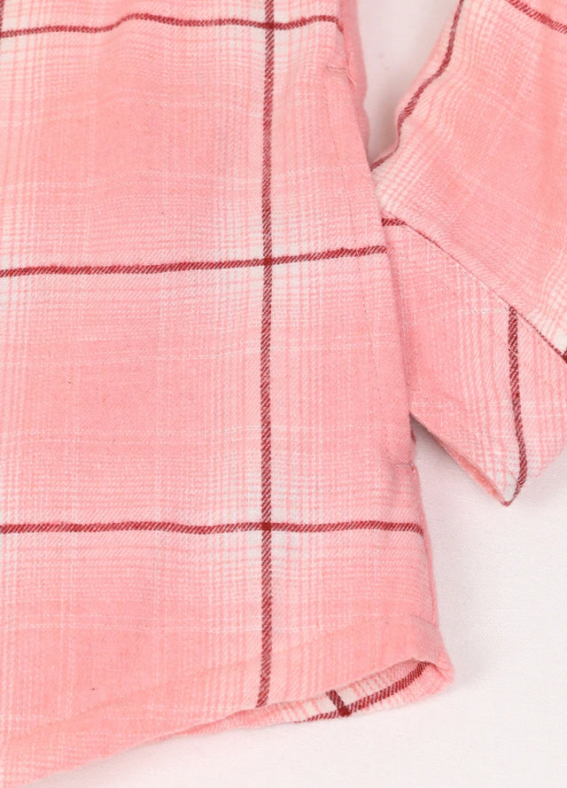 Detailed view of women's pink sherpa-lined flannel shacket hand pocket