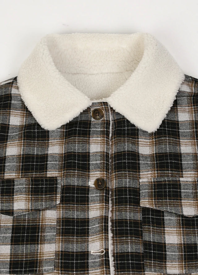 Close-up of women's winter warm black plaid flannel jacket collar