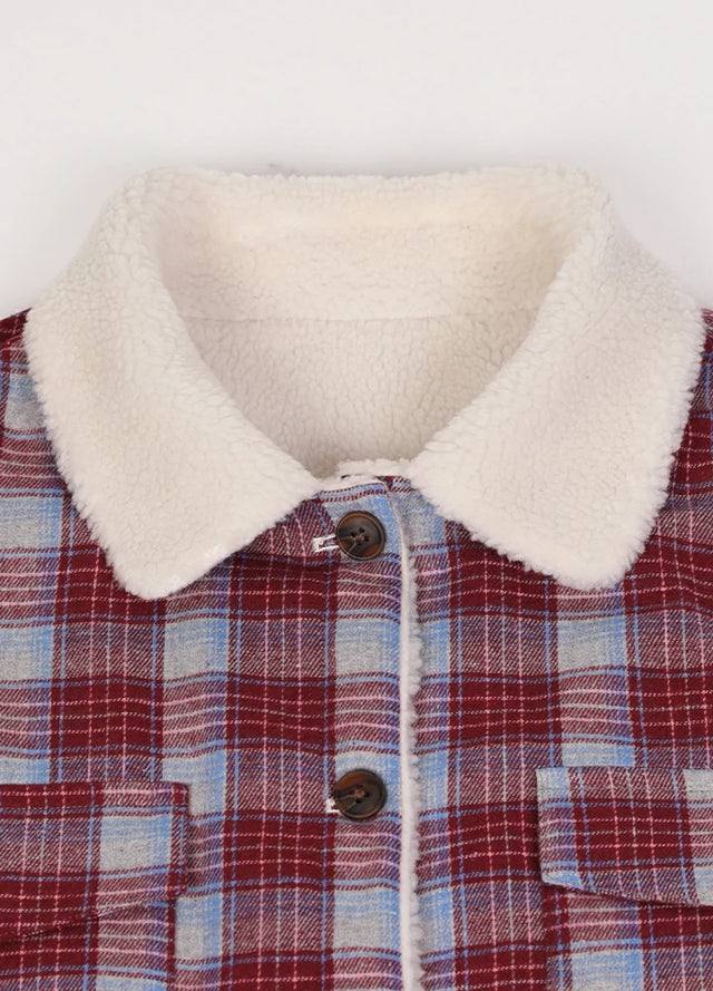 Close-up of women's winter warm burgundy plaid flannel jacket collar