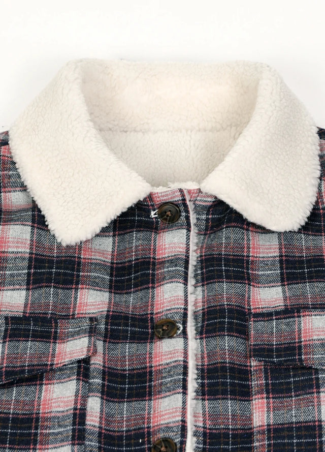 Close-up of women's winter warm navy pink plaid flannel jacket collar