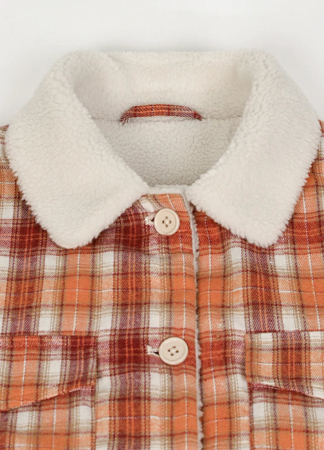 Close-up of women's winter warm orange plaid flannel jacket collar