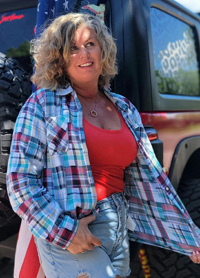 Side view of women in a long sleeve blue and white irregular plaid shirt