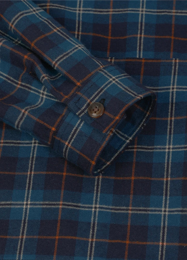 Detail view of the cuff of a blue and navy women's casual quarter zip flannel shirt