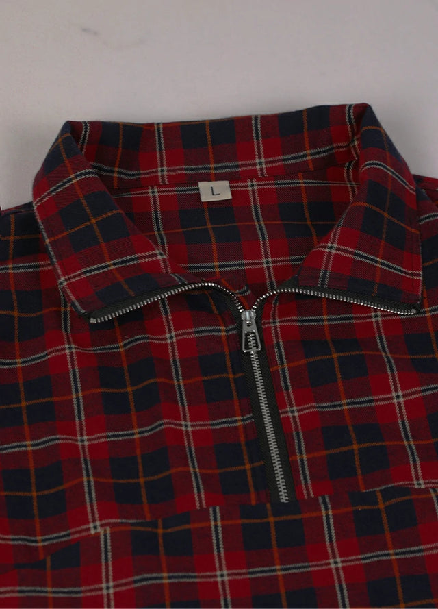 Close-up of the neckline of red and navy women's quarter zip flannel shirt