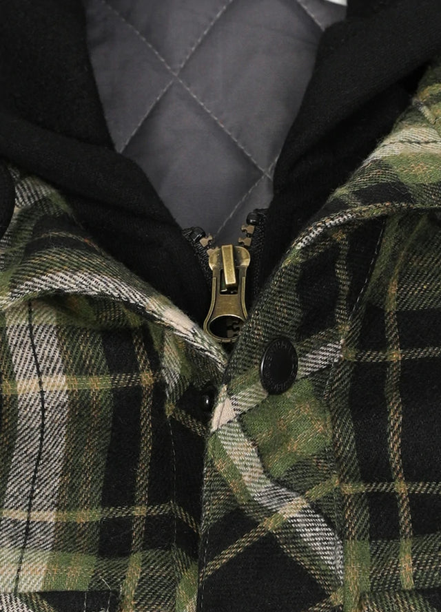 Close-up of the zipper of green and black men's quilted lined plaid flannel hooded