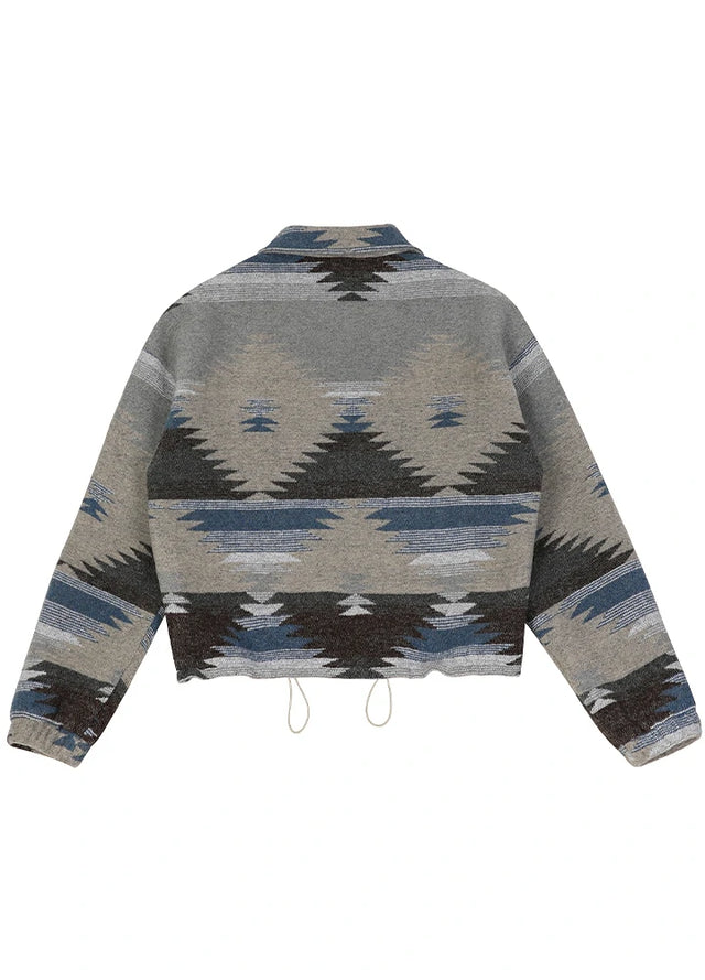 Back view of a women's gray blue aztec cropped jacket with hem drawcord adjustment