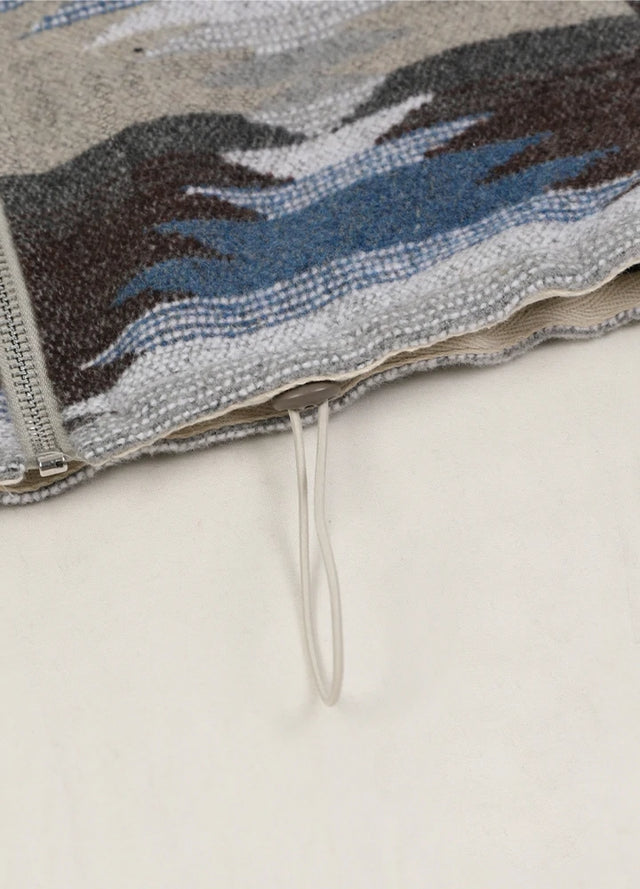 Detailed view of womens gray blue full zip aztec cropped jacket hem