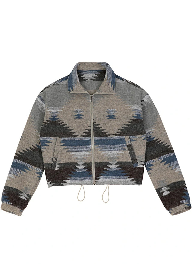 Front view of a women's aztec zip up gray blue cropped jacket with elastic cuffs