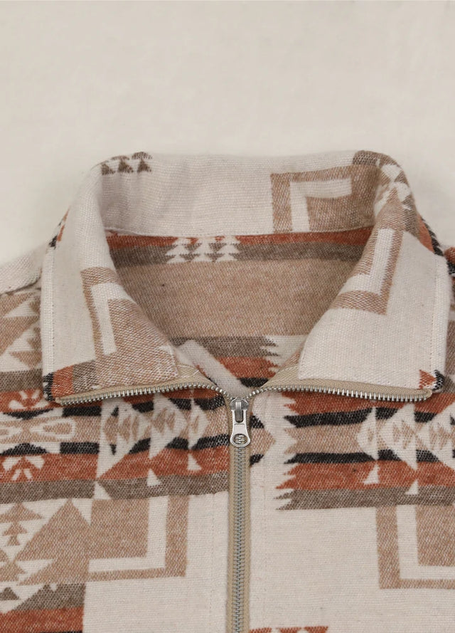 Close-up of the lapel on a women's khaki brown aztec cropped shirt jacket