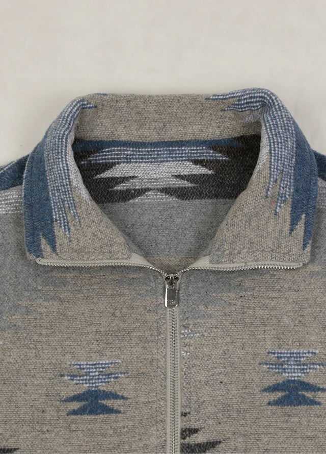 Close-up of the lapel on a women's gray blue aztec cropped shirt jacket