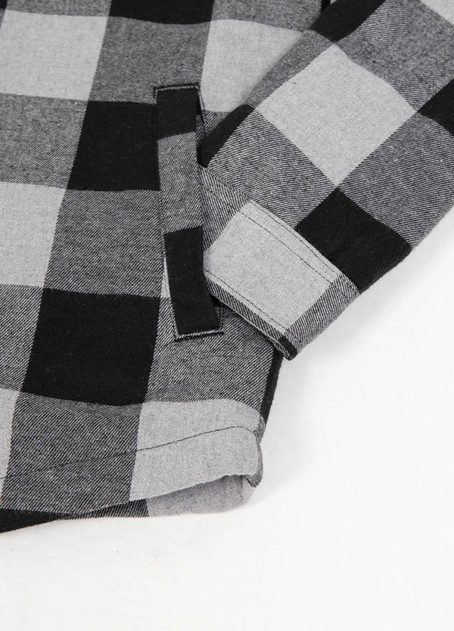 Close-up of the hand pocket of a gray black men's soft snap button flannel plaid jacket