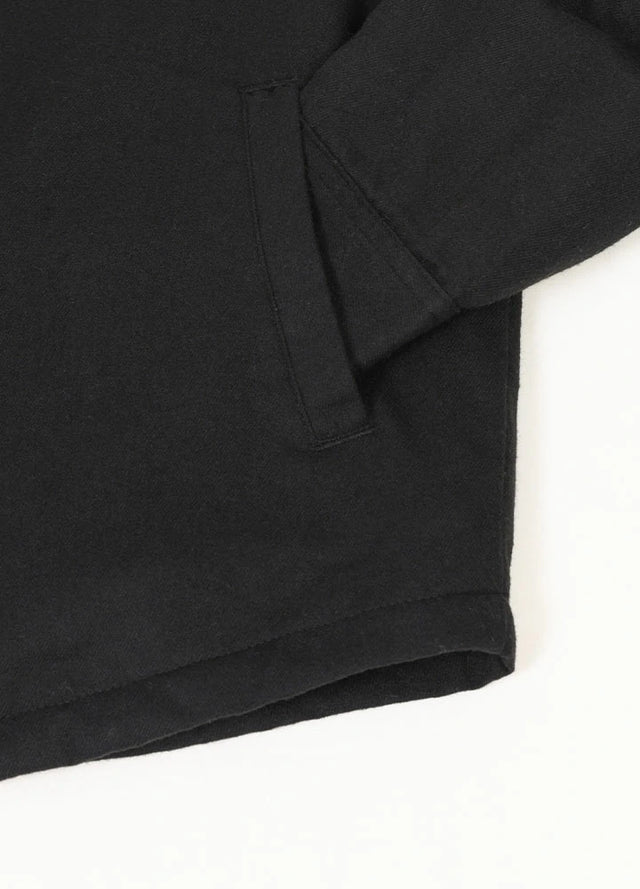 Close-up of the hand pocket of men's black soft sherpa lined flannel jacket