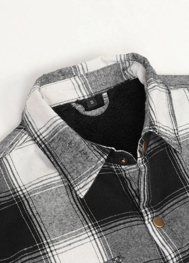 Close-up of the lapel of black white men's cozy snap button flannel shirt jacket