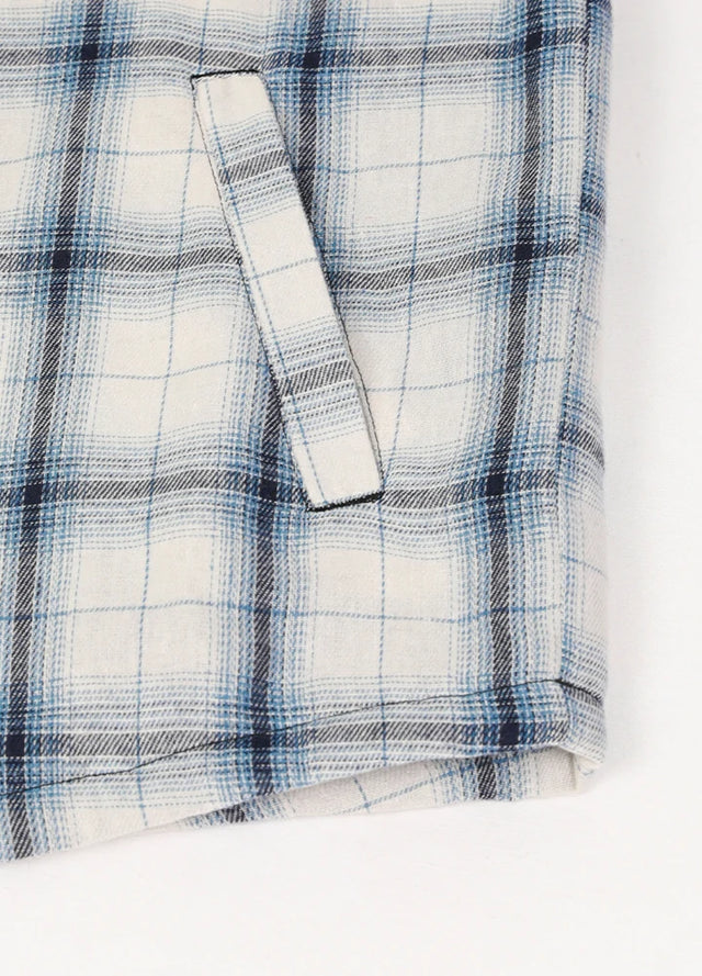 Close-up of the hand pocket of blue and white plaid fleece lined flannel shacket for men