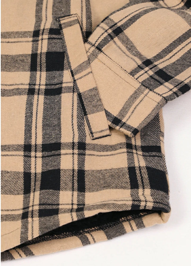 Close-up of the hand pocket of khaki black war sherpa lined flannel shacket for men