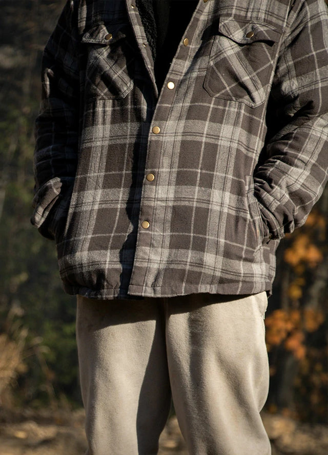 Front view of a man wearing a gray men's flannel shirt jacket with hands in pockets