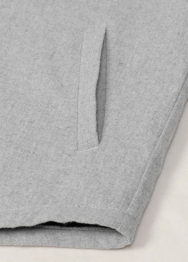 Close-up of the hand pocket of ash men's cozy flannel jacket with sherpa lining