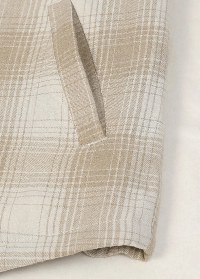 Close-up of the hand pocket of a khaki beige men's warm flannel jacket with sherpa lining