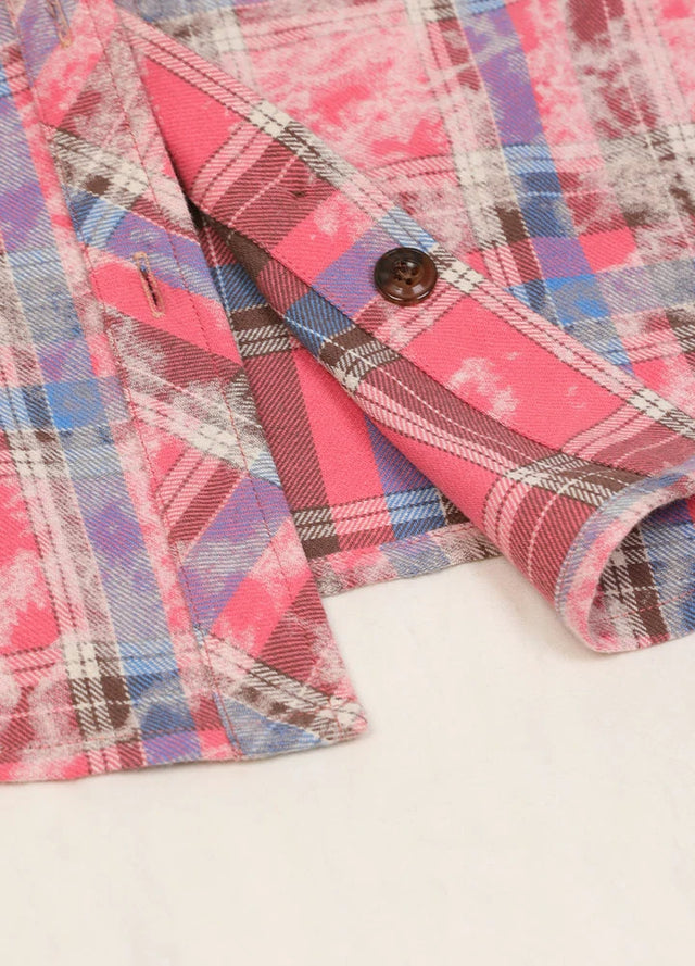 Zoomed-in view of the hem on a Women's flannel rose pink plaid shirt with chest pocket