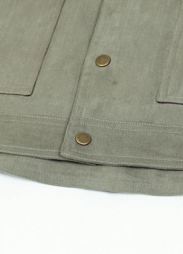 Detailed view of the hem of the light green men's casual flannel plaid shirt jacket
