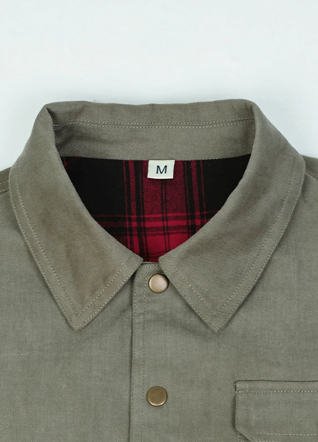 Close-up of the lapel of the light green men's casual flannel lined plaid jacket