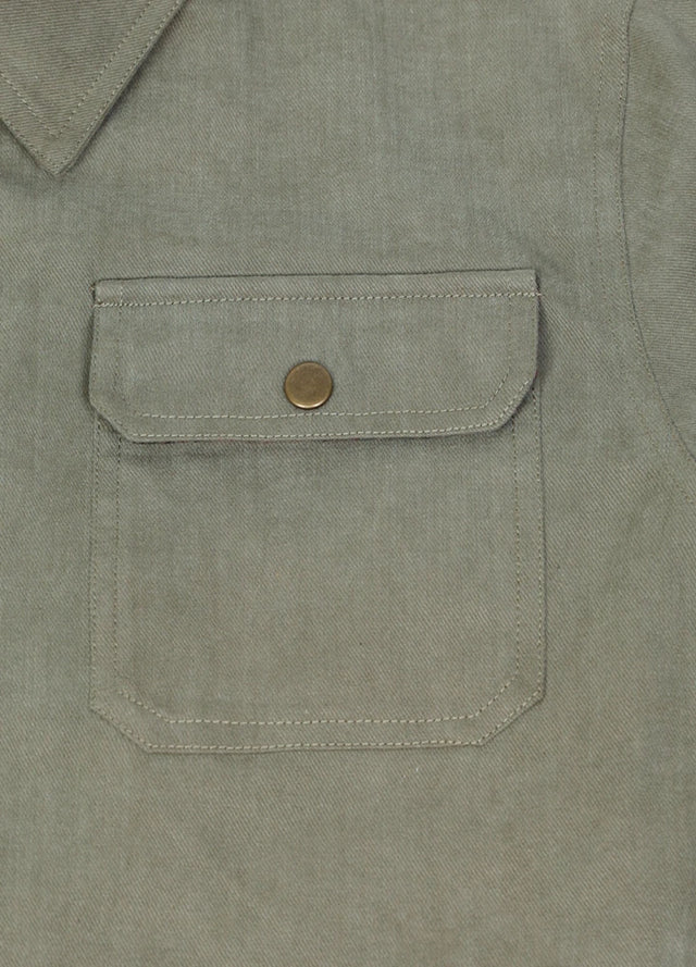 Close-up of the pocket of the light green men's casual flannel lined plaid jacket