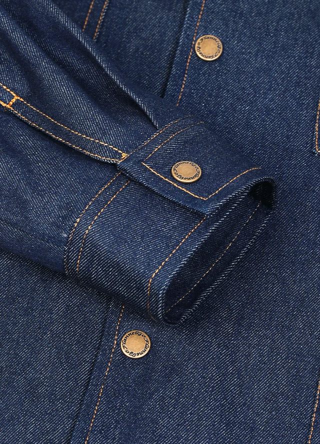 Close-up of a dark blue denim jacket for men with cuff and stitching details.