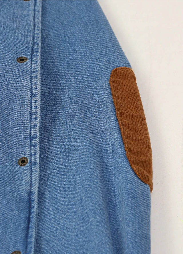 Detail view of the elbows of a men's blue cozy flannel lined denim shacket