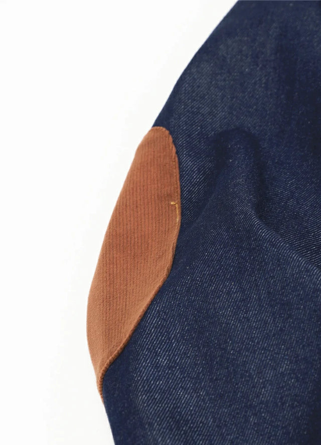 Detail view of the elbows of dark blue men's flannel lined denim jacket