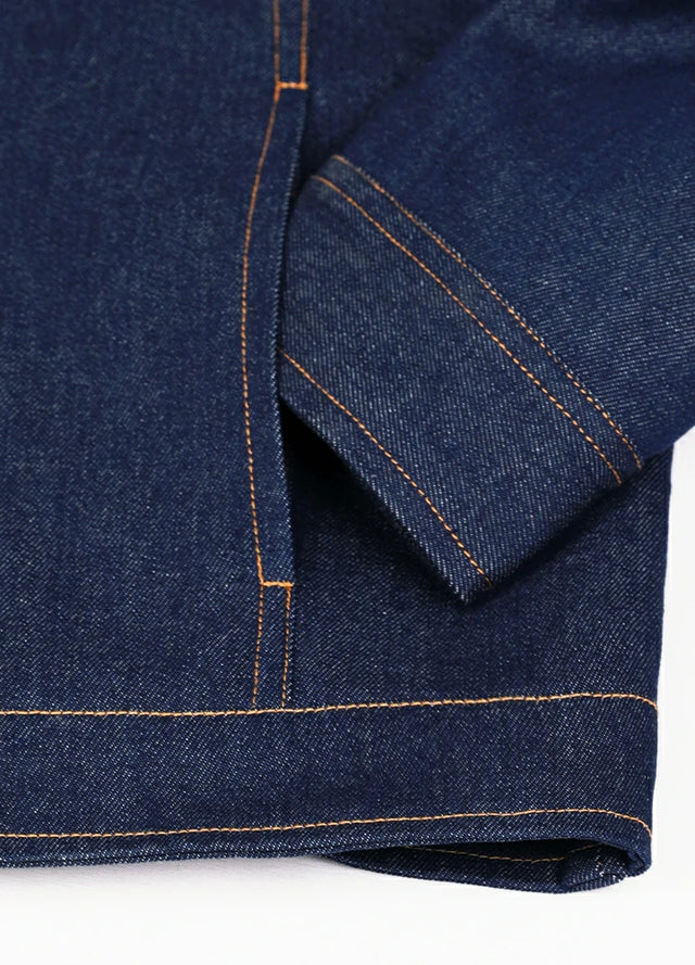 Detail view of the hand pocket of a dark blue denim shirt jacket for men