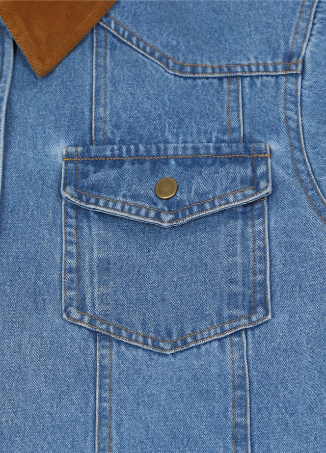 Detail view of the pocket of men's blue cozy flannel lined denim shacket
