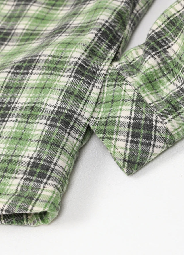 Zoomed-in of women's button down green gray plaid flannel jacket hand pocket