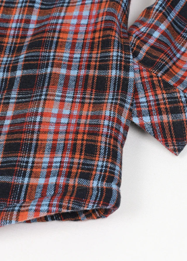 Zoomed-in of women's button down orange black plaid flannel jacket hand pocket