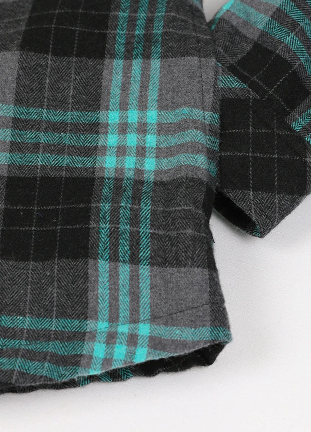 Zoomed-in of women's button down turquoise gray plaid flannel jacket hand pocket