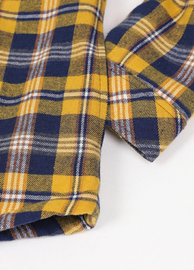 Zoomed-in of women's button down yellow blue plaid flannel jacket hand pocket