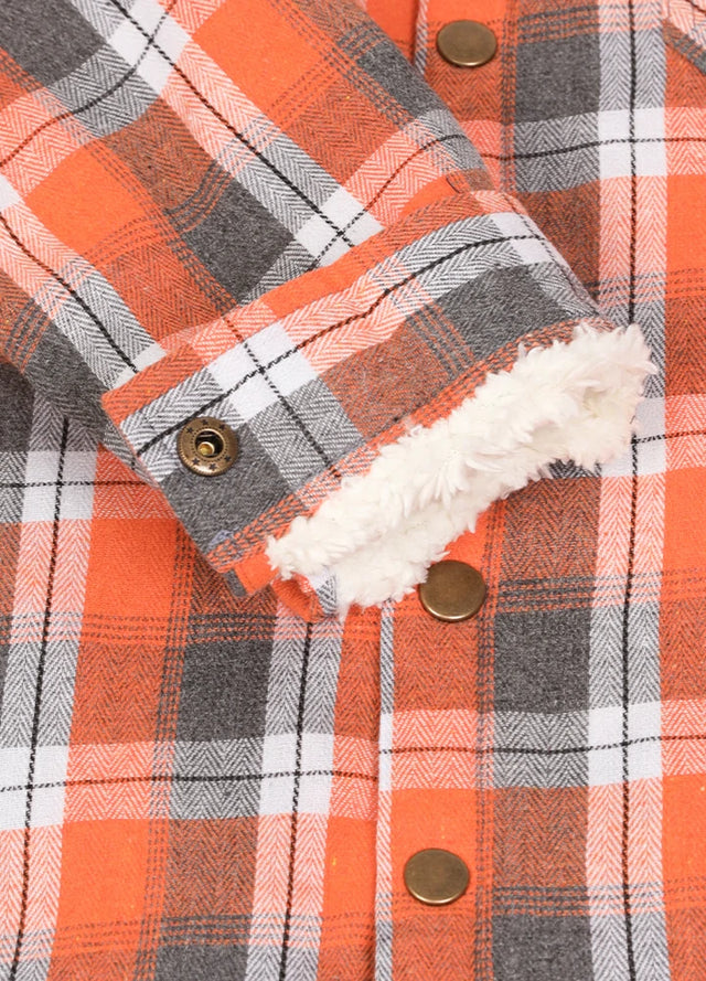 Close-up of cuff with button on kids Orange Gray plaid flannel jacket