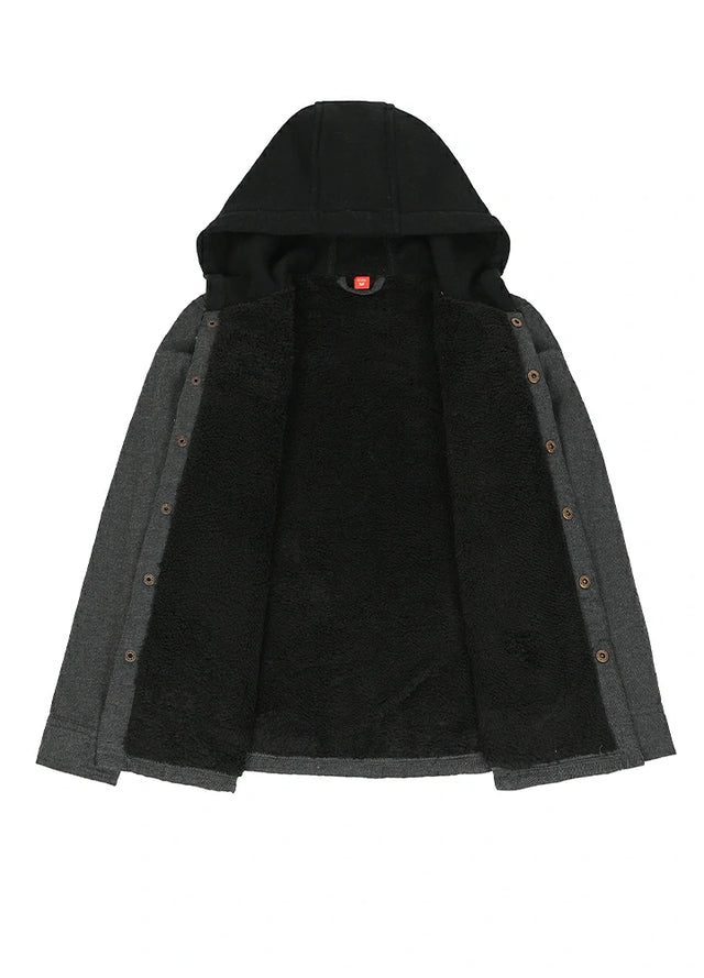 Detailed view of the inner lining on kid's black hooded flannel jacket